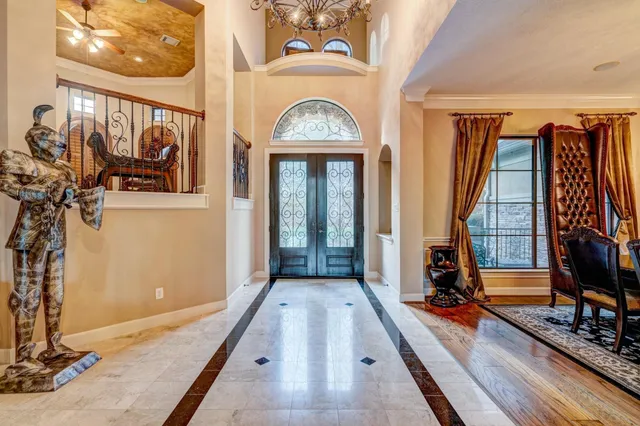 a view of hall way with mirror and furniture
