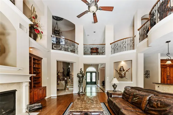 a living room with furniture kitchen view and a large window