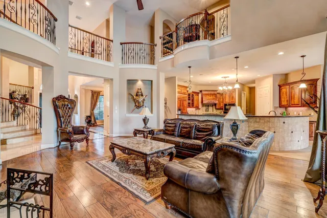 a kitchen with stainless steel appliances granite countertop a stove top oven a sink a counter space and cabinets