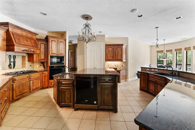 a kitchen with stainless steel appliances granite countertop a stove and a sink