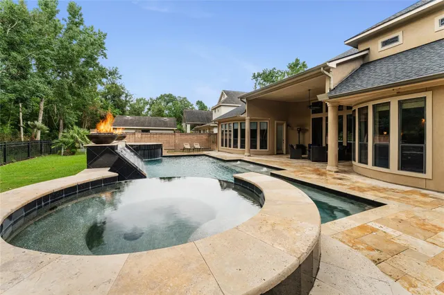 a view of a house with swimming pool and sitting area