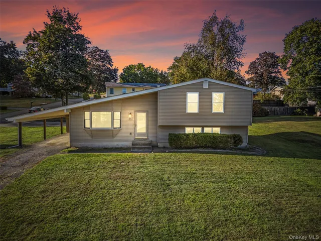 a house that has a tree in front of it