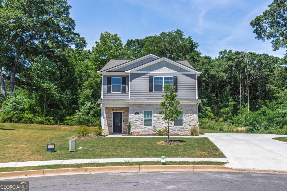 653 Meadows Farm Way Monroe, GA 30655 - Photo 5 of 34 a front view of a house with a yard