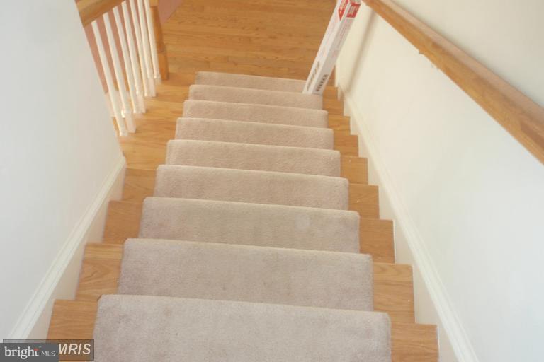 760 Holly Leaf Road Culpeper, VA 22701 - Photo 12 of 26 a view of staircase with white walls and white door