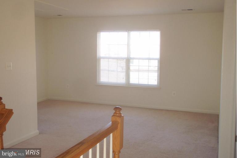 760 Holly Leaf Road Culpeper, VA 22701 - Photo 18 of 26 a view of a small space with wooden floor and a window