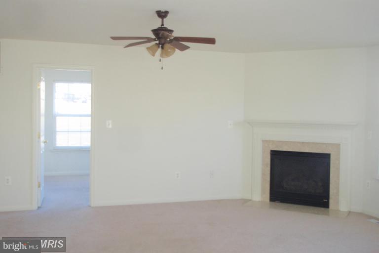 760 Holly Leaf Road Culpeper, VA 22701 - Photo 7 of 26 a view of an empty room with a fireplace