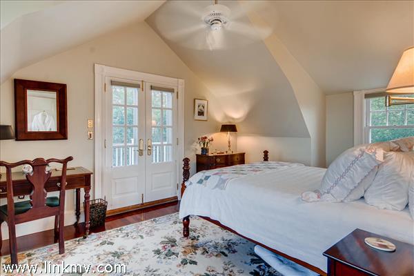 7 Starbuck Neck Road Edgartown, MA 02539 - Photo 33 of 41 a bedroom with a bed and wooden floor