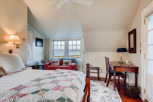 7 Starbuck Neck Road Edgartown, MA 02539 - Photo 34 of 41 a bedroom with a bed and a table in it