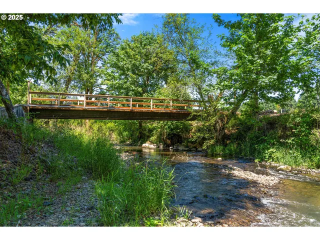 a view of a lake with a bench under an umbrella