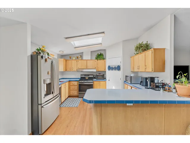 a kitchen with a refrigerator and a sink