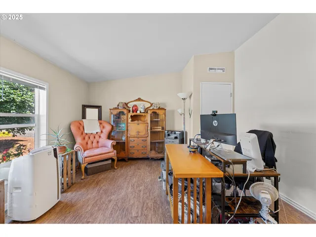 a workspace with furniture and a wooden floor