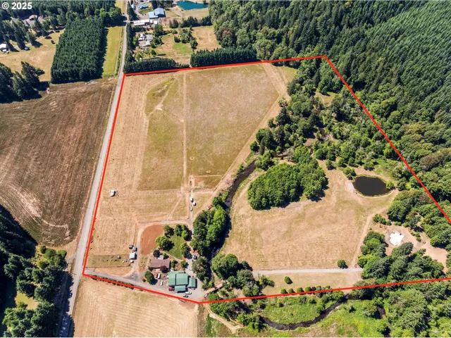 an aerial view of a house with a yard and garden