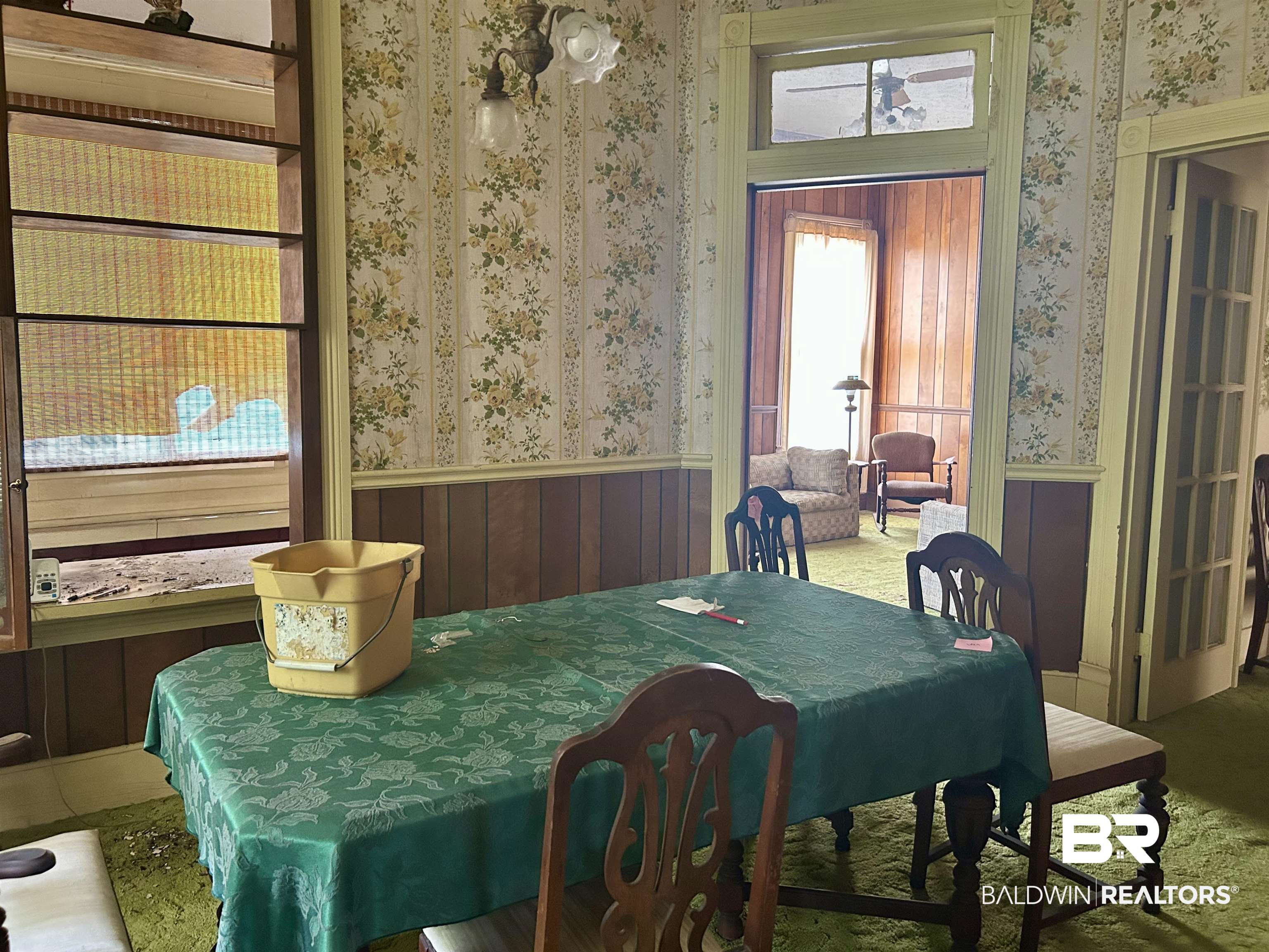 302 Stocking Street Mobile, AL 36604 - Photo 8 of 31 Room featuring floral wallpaper, wood paneling, and an overhead light fixture