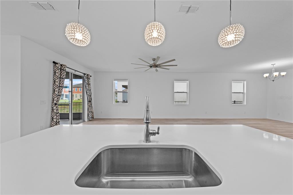 920 Livestock Loop St. Cloud, FL 34771 - Photo 15 of 55 a close view of sink a faucet cabinets and stainless steel appliances