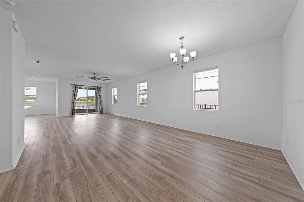 920 Livestock Loop St. Cloud, FL 34771 - Photo 19 of 55 an empty room with wooden floor and windows