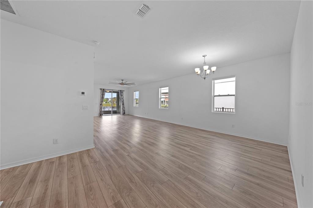 920 Livestock Loop St. Cloud, FL 34771 - Photo 20 of 55 an empty room with wooden floor and windows