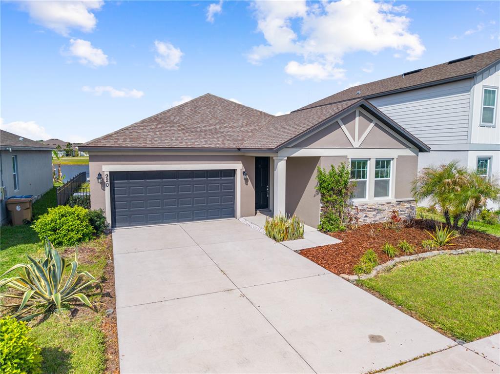 920 Livestock Loop St. Cloud, FL 34771 - Photo 2 of 55 a front view of a house with garden