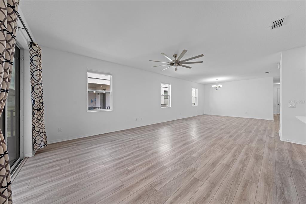 920 Livestock Loop St. Cloud, FL 34771 - Photo 21 of 55 a view of an empty room with a window and wooden floor