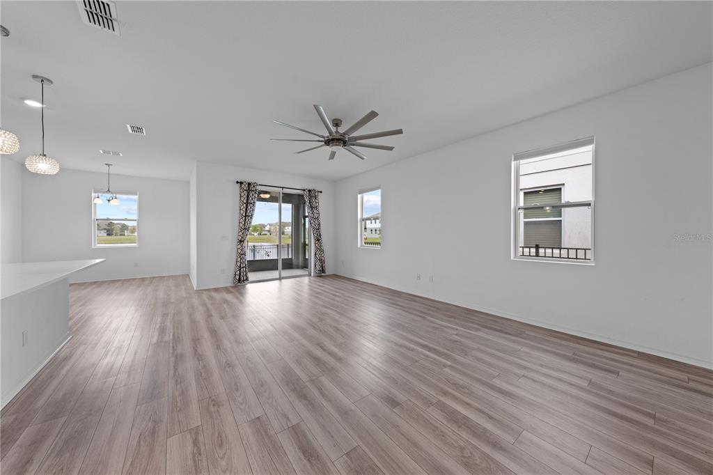 920 Livestock Loop St. Cloud, FL 34771 - Photo 22 of 55 wooden floor in an empty room with a window