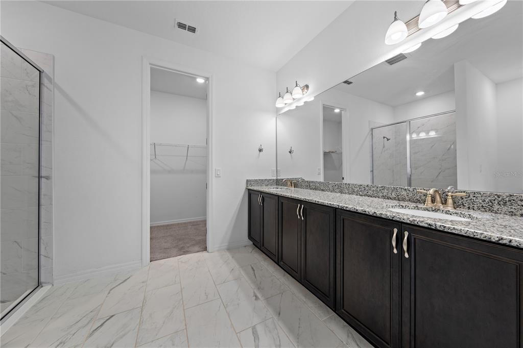 920 Livestock Loop St. Cloud, FL 34771 - Photo 28 of 55 a bathroom with a double vanity sink and a mirror