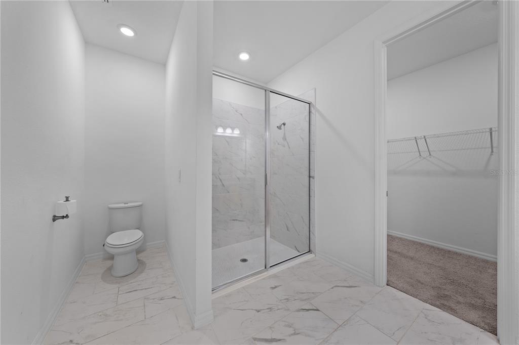 920 Livestock Loop St. Cloud, FL 34771 - Photo 29 of 55 a bathroom with a shower and toilet