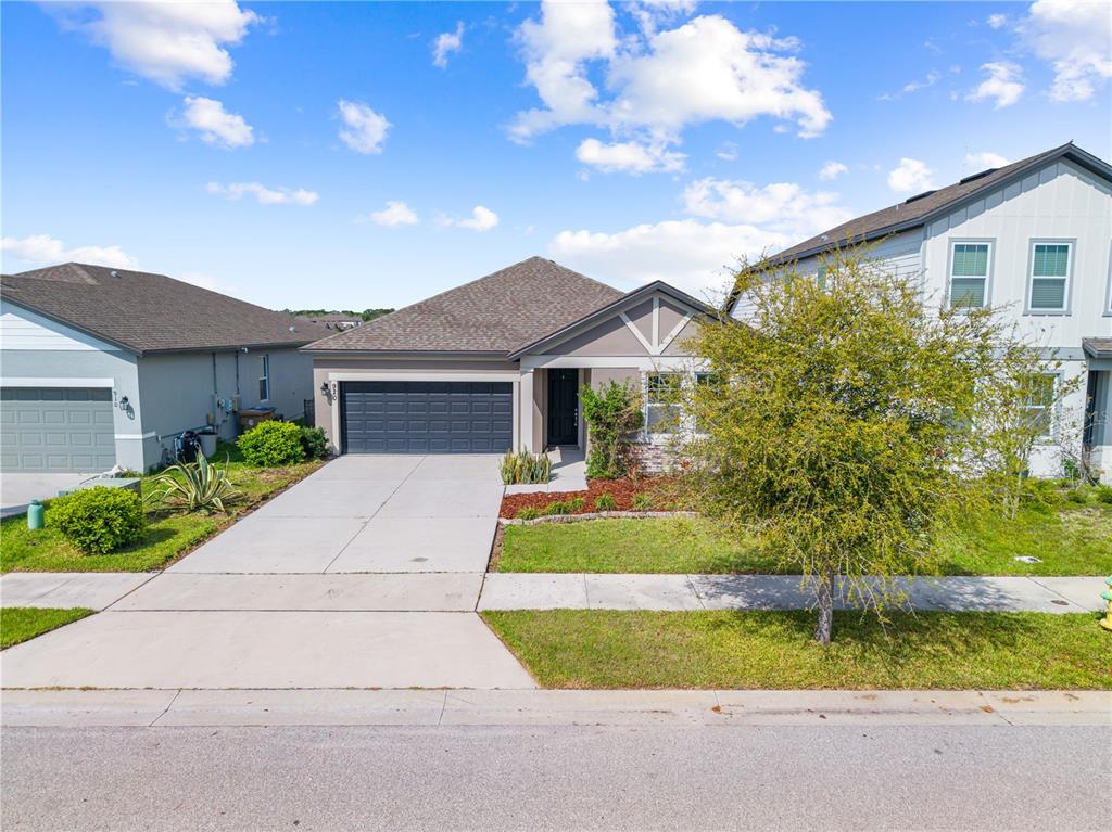 920 Livestock Loop St. Cloud, FL 34771 - Photo 3 of 55 a front view of a house with a yard and garage