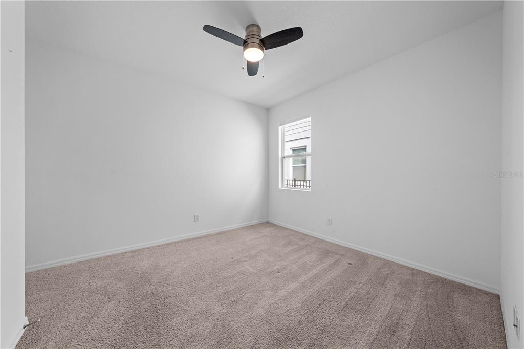 920 Livestock Loop St. Cloud, FL 34771 - Photo 31 of 55 an empty room with a window and a ceiling fan