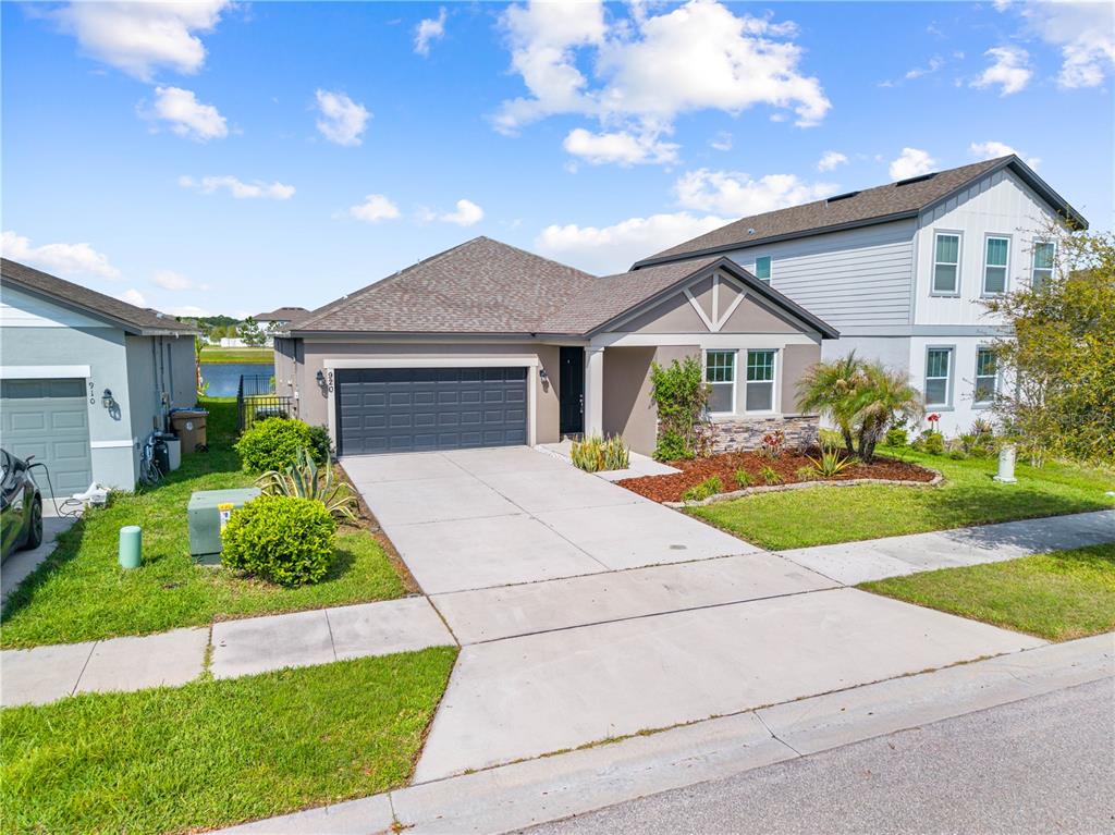 920 Livestock Loop St. Cloud, FL 34771 - Photo 4 of 55 a front view of a house with a yard and potted plants
