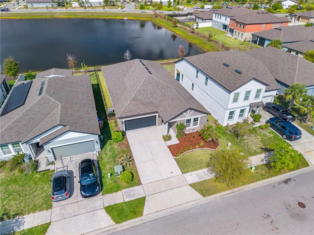 920 Livestock Loop St. Cloud, FL 34771 - Photo 53 of 55 an aerial view of a house with garden space and lake view