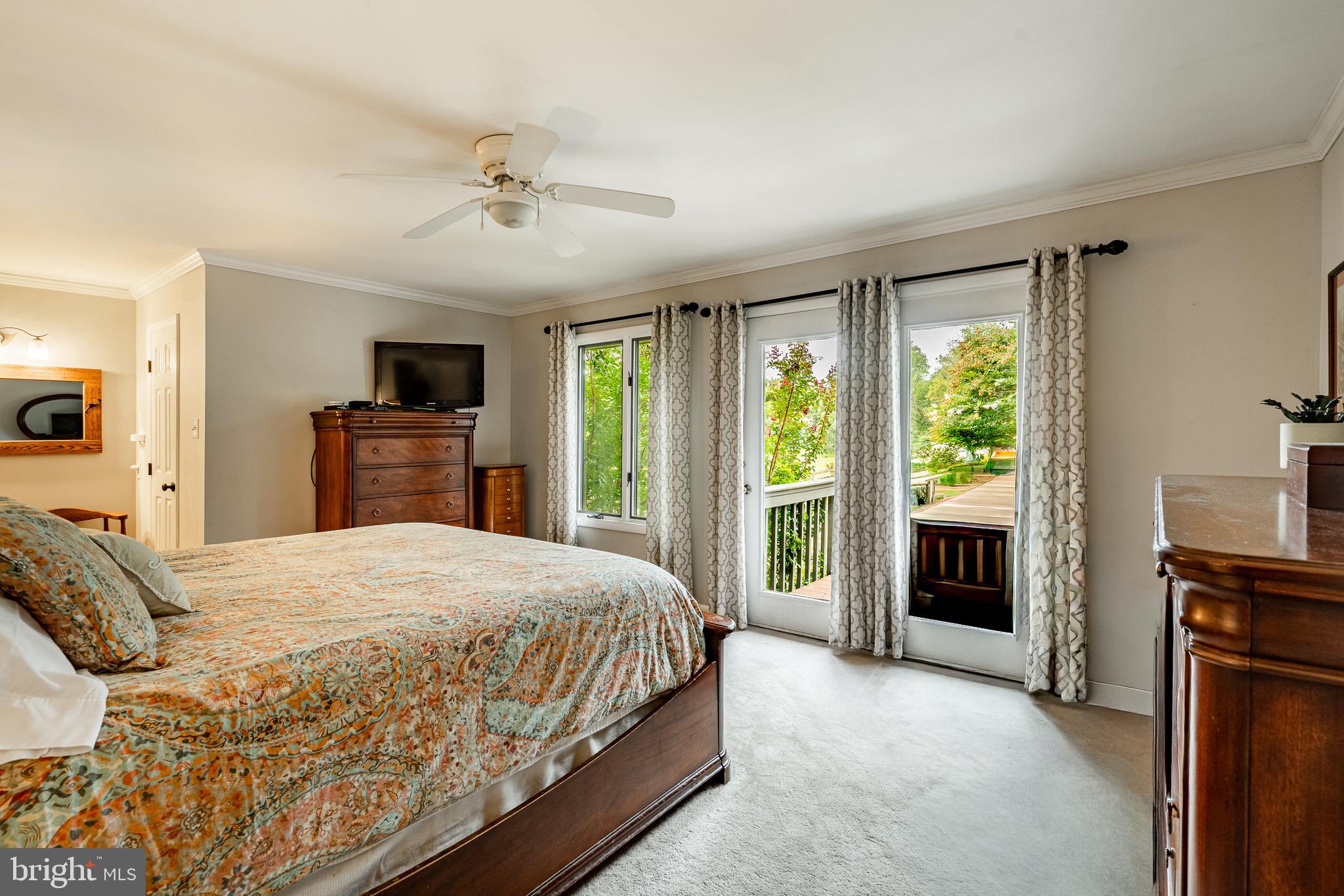 19 Ringfield Road, Unit 19 Chadds Ford, PA 19317 - Photo 18 of 39 a spacious bedroom with a large bed and a flat tv screen on dresser