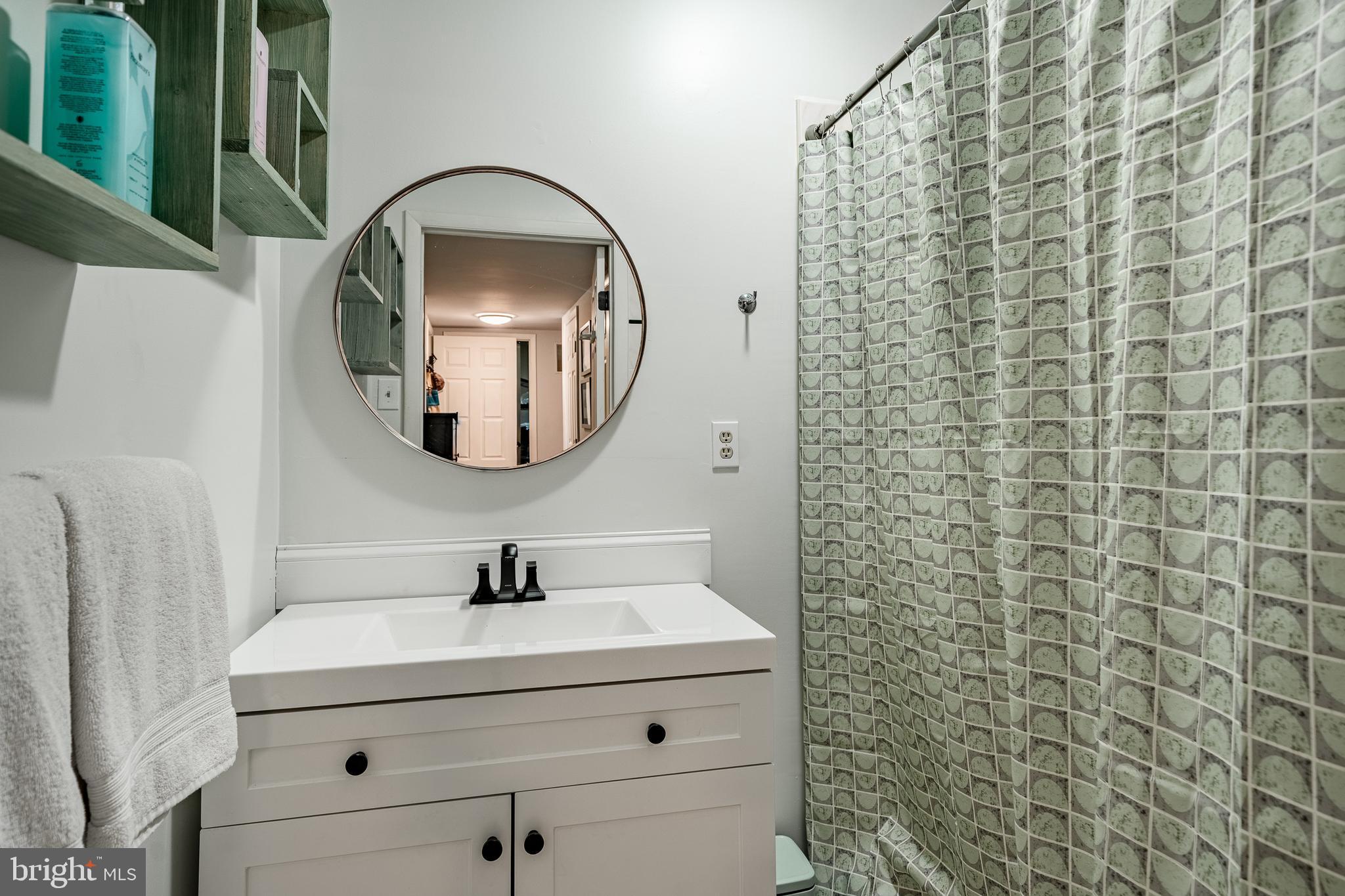 19 Ringfield Road, Unit 19 Chadds Ford, PA 19317 - Photo 33 of 39 a bathroom with a sink a mirror and shower