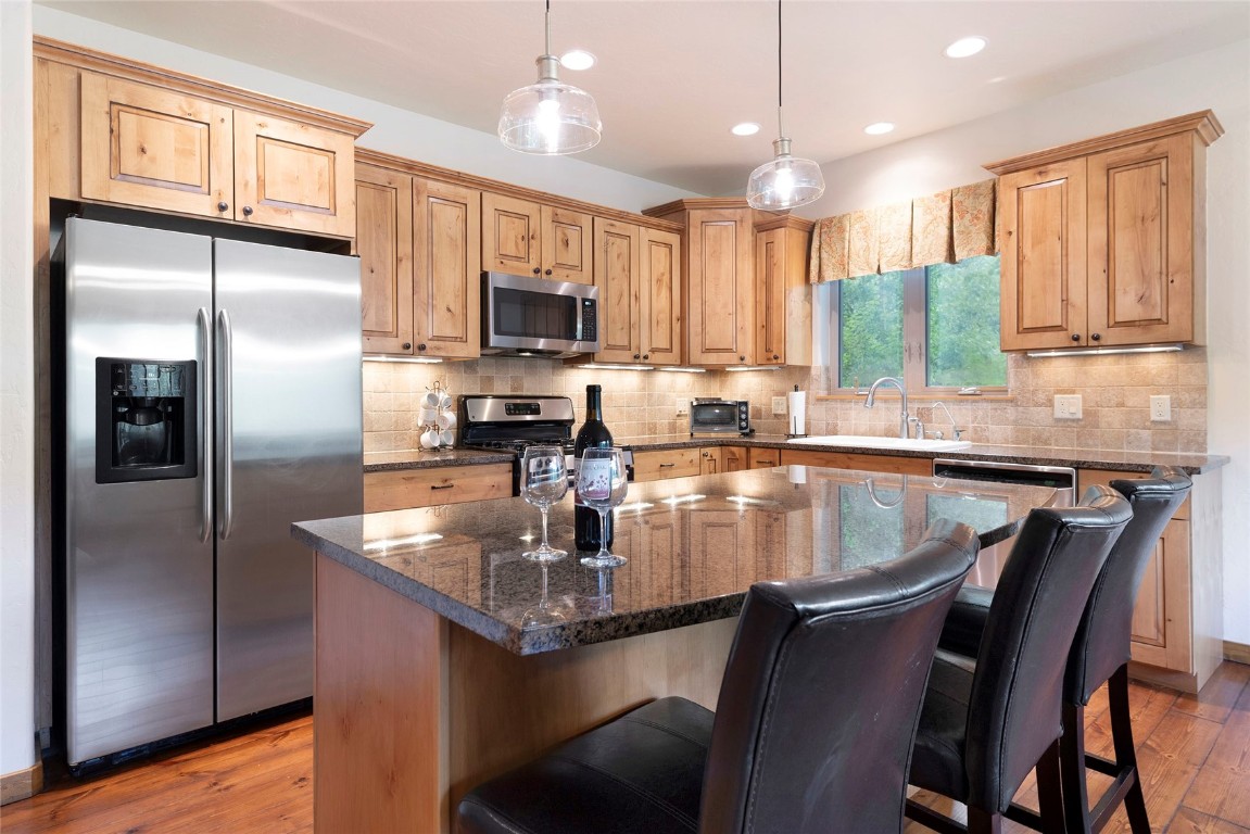 9 Davis Court Blue River, CO 80424 - Photo 11 of 44 a kitchen with kitchen island granite countertop a sink appliances cabinets and furniture