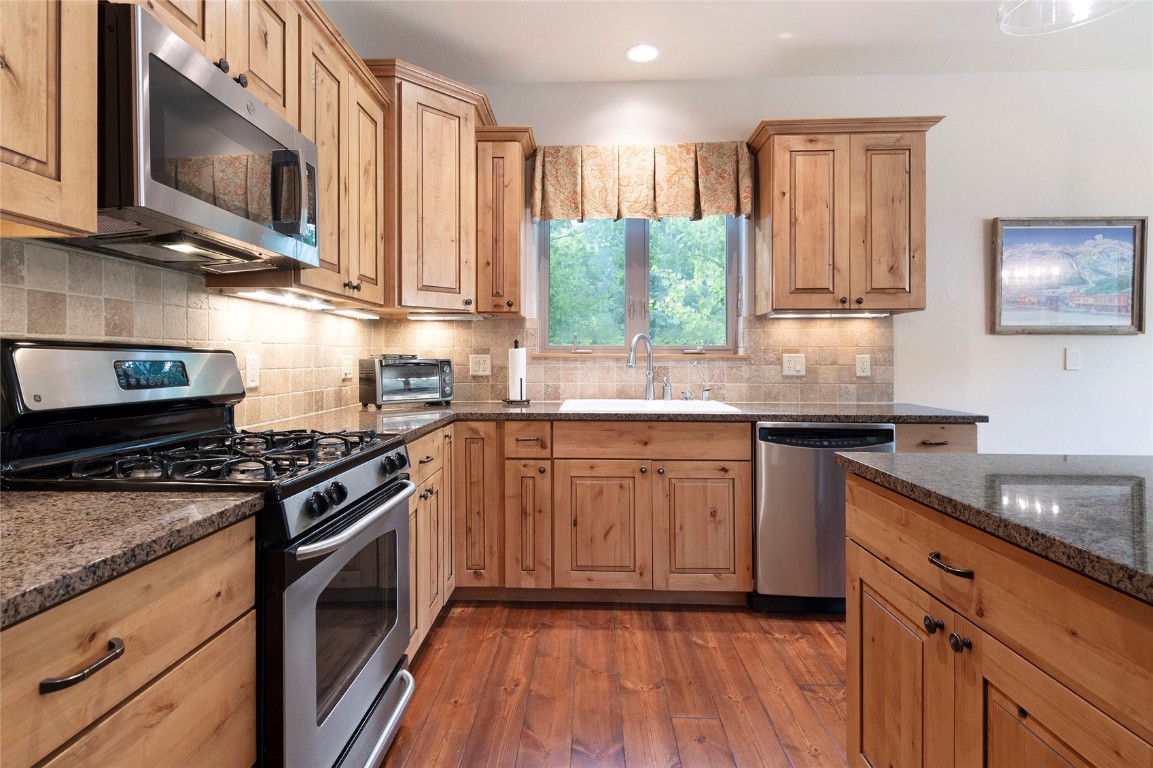 9 Davis Court Blue River, CO 80424 - Photo 13 of 44 a kitchen with stainless steel appliances granite countertop a stove a sink and a microwave