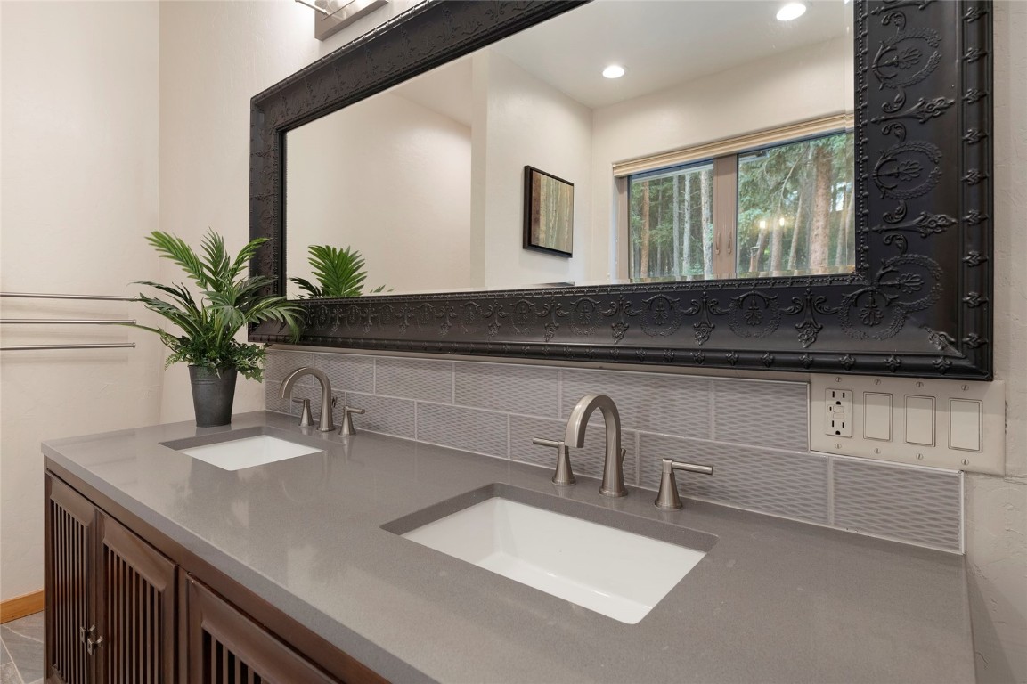 9 Davis Court Blue River, CO 80424 - Photo 22 of 44 a bathroom with a sink a potted plant and a mirror
