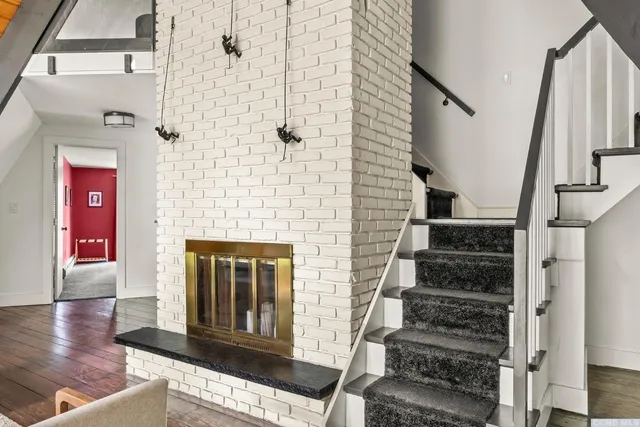 a view of a hallway with wooden floor and entryway