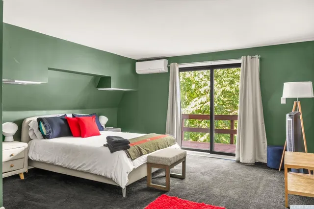 a bedroom with a bed and a large window