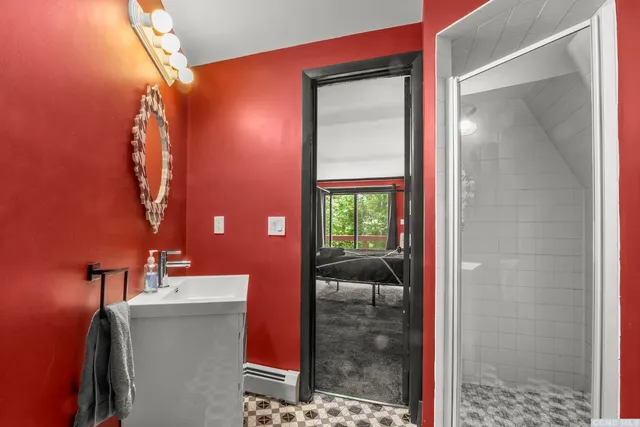 a bathroom with a mirror and a shower