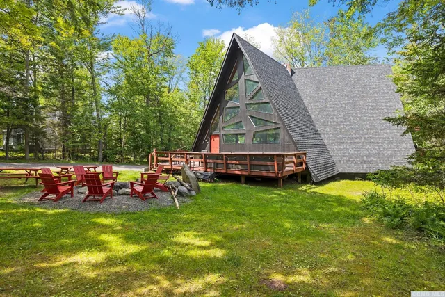 an aerial view of a house with garden space and sitting area