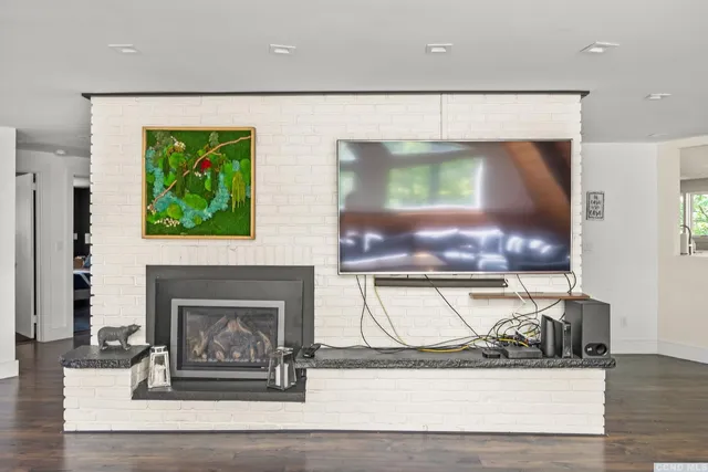 a view of living room with furniture and a fireplace