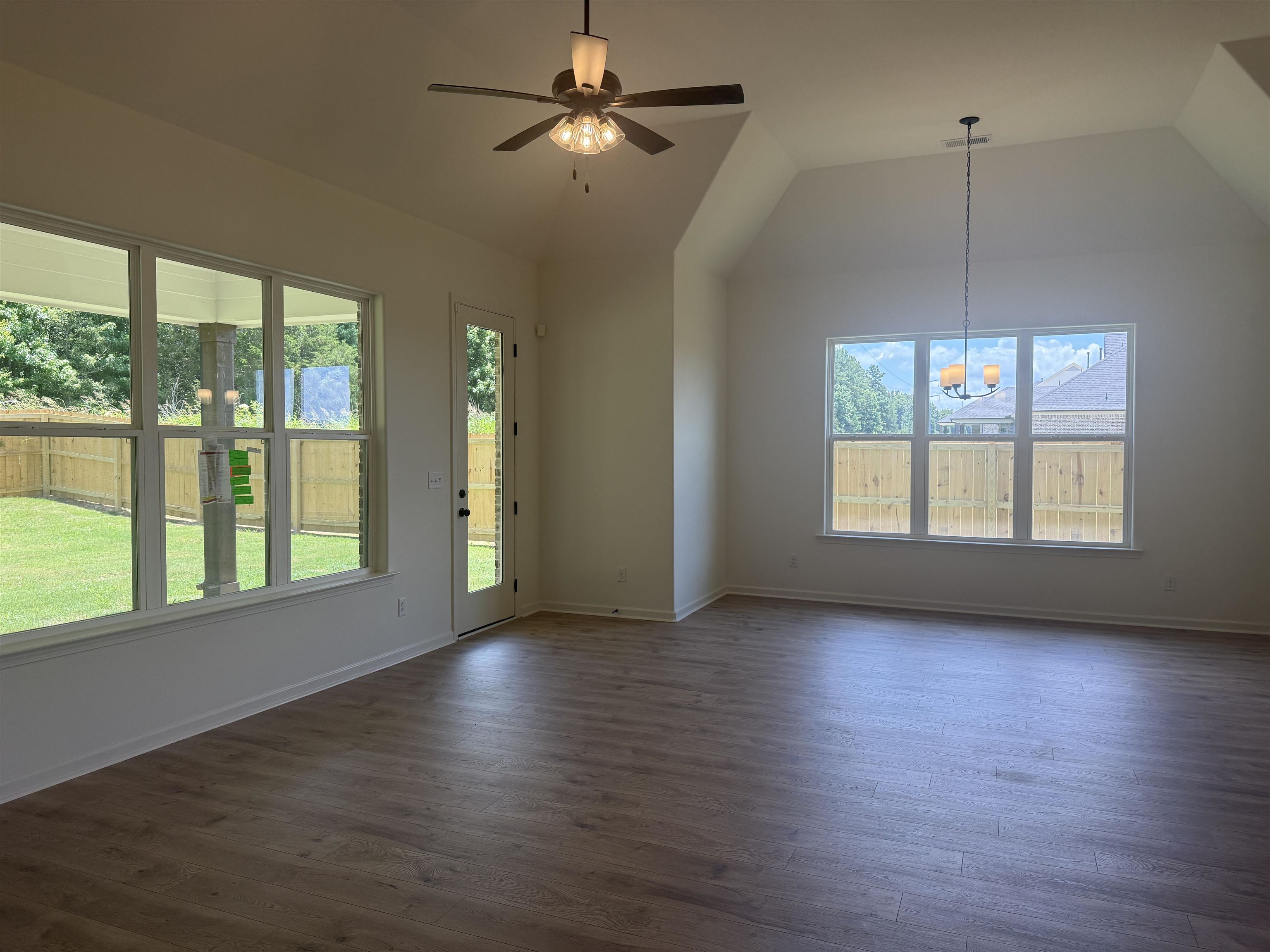 85 Ridgefield Drive Oakland, TN 38060 - Photo 4 of 12 a view of an empty room with wooden floor and a window