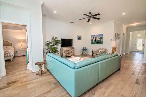 a living room with furniture and a wooden floor