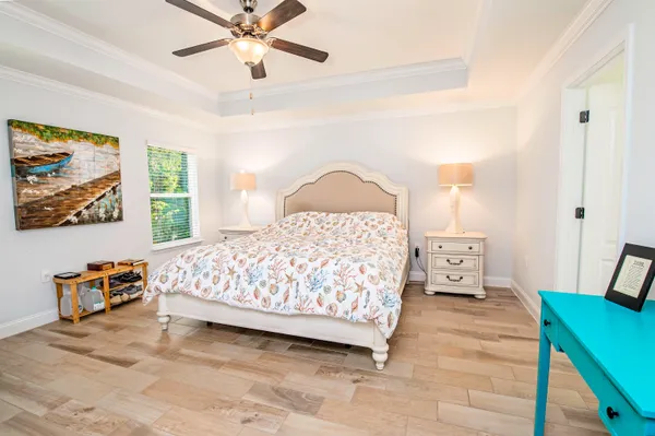 a bedroom with a bed and a chandelier