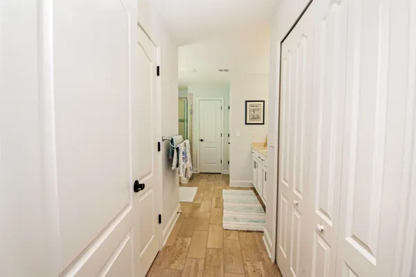 a view of a bathroom with a sink and a wooden floor