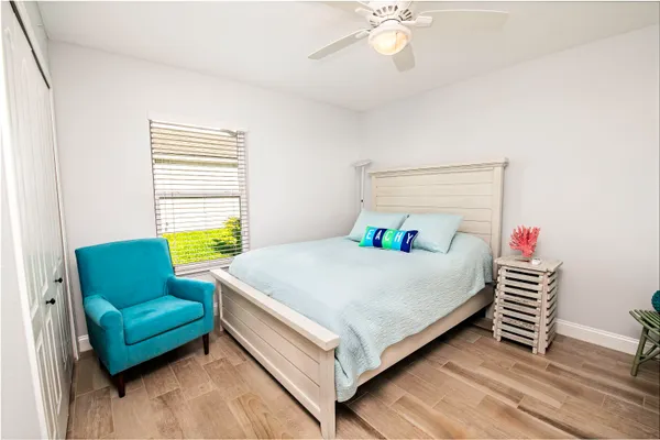 a bed room with a bed and a chair