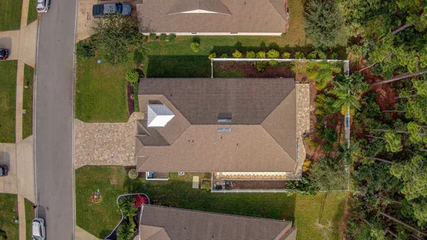 an aerial view of a house with a yard