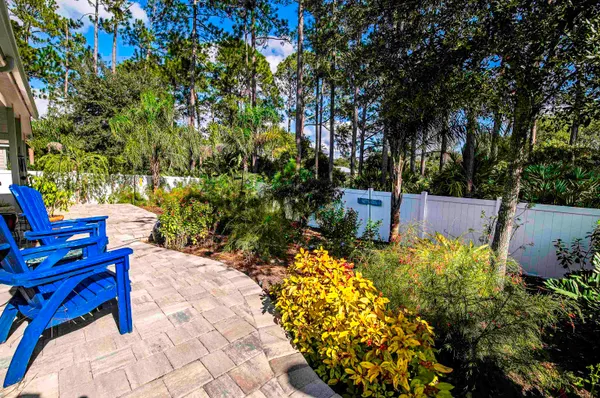 a view of a chair and table in the garden