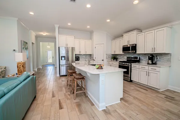 a kitchen with white cabinets and stainless steel appliances