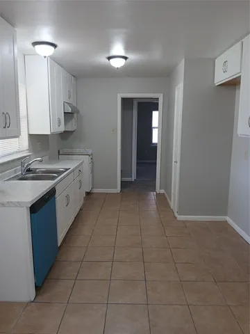 a kitchen with stainless steel appliances a sink a stove a refrigerator and cabinets