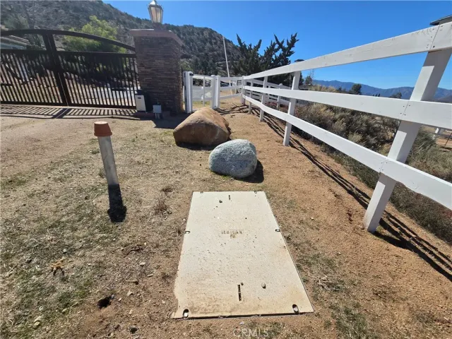 a view of a dry yard with mountains in the background