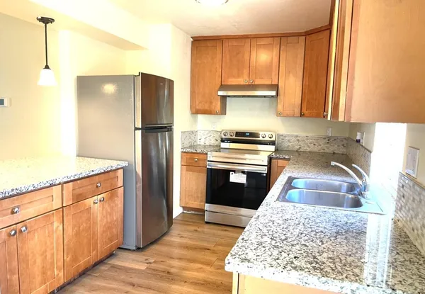 a kitchen with a refrigerator sink and cabinets